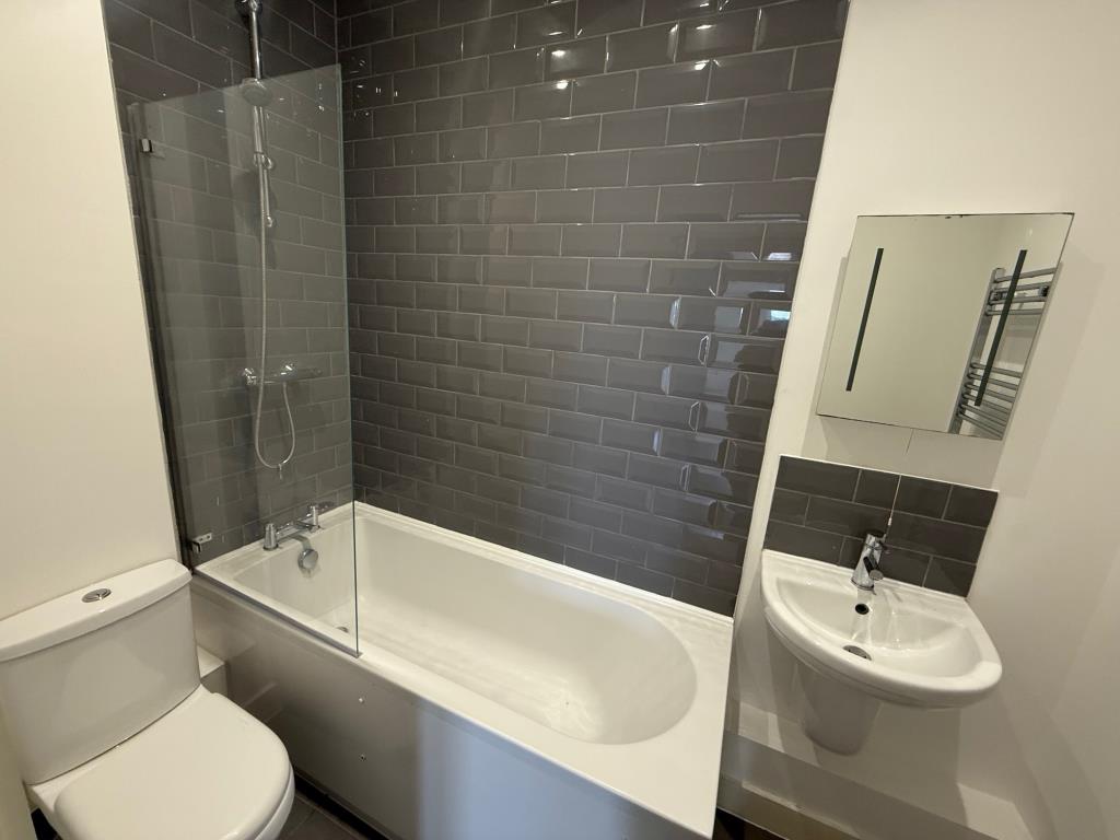 Lot: 128 - FLAT FOR INVESTMENT - Bathroom with modern fitted bathroom suite and grey tiles